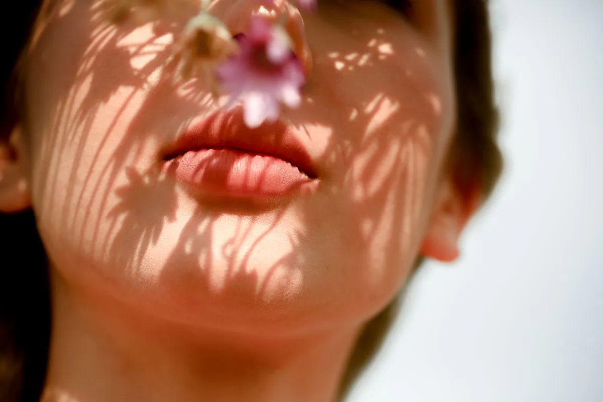 woman's face closeup and wildflower